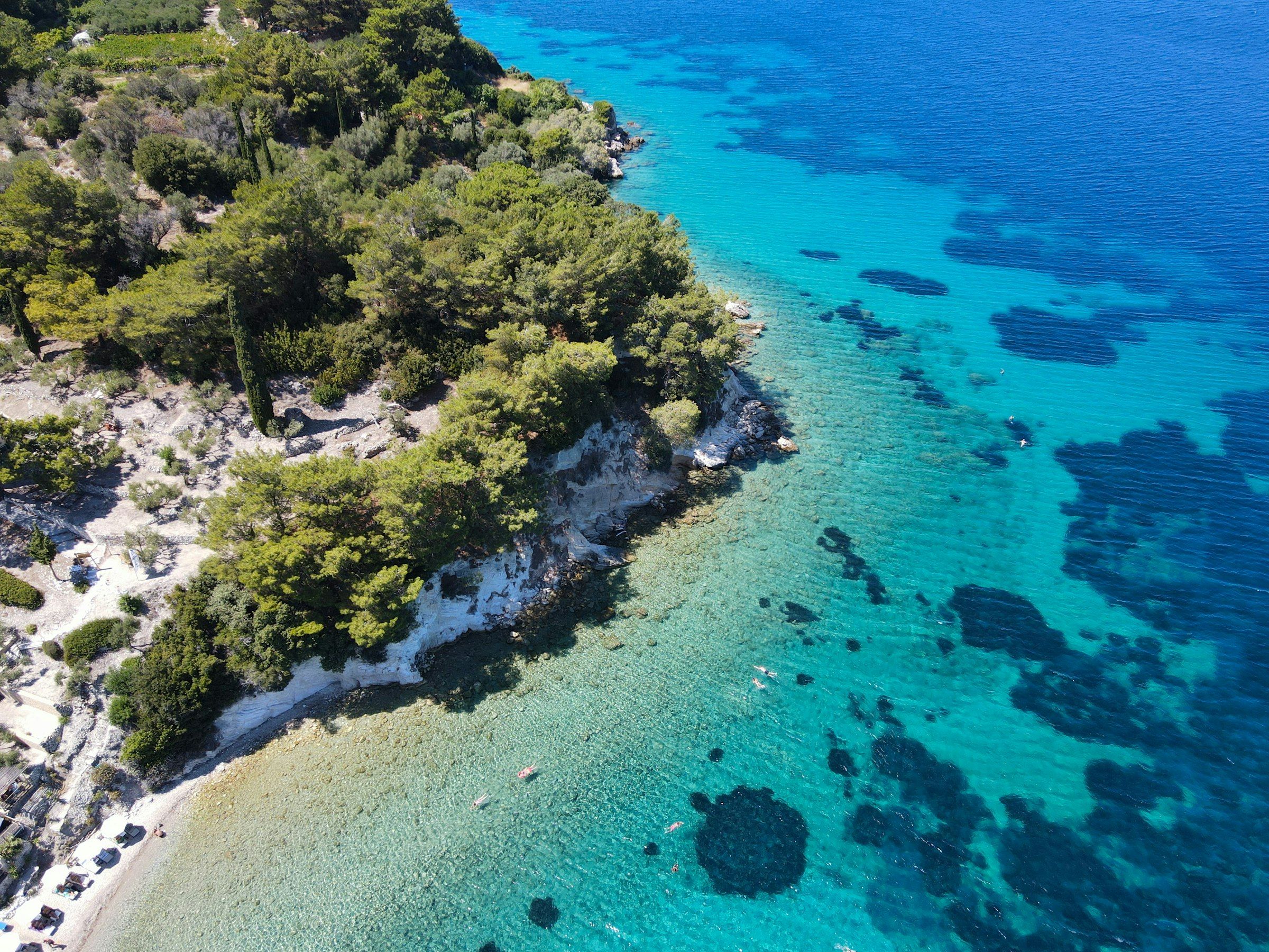 Aerial view of a beach with clear turquoise water