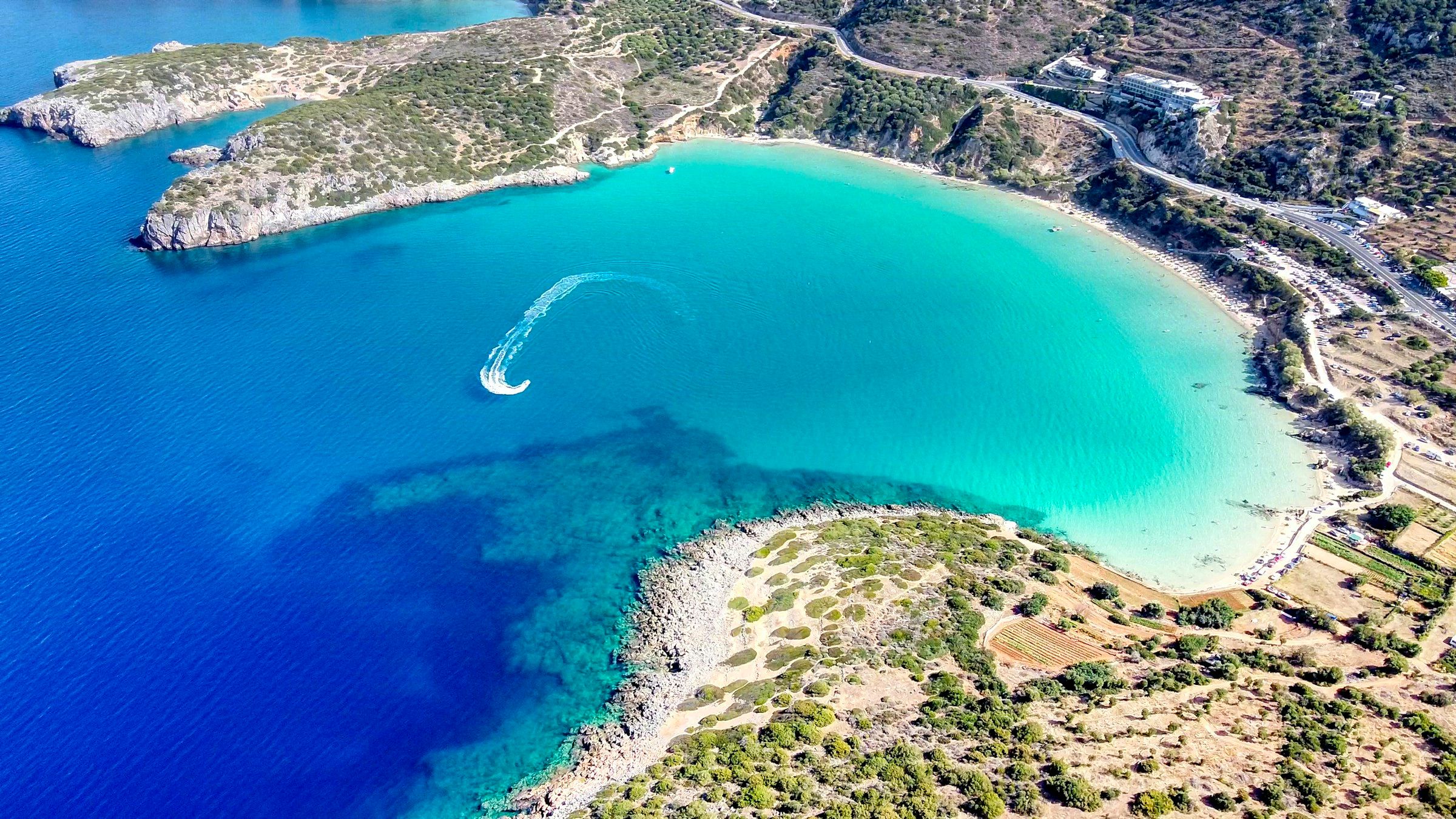 Aerial view of a sandy beach and clear blue water