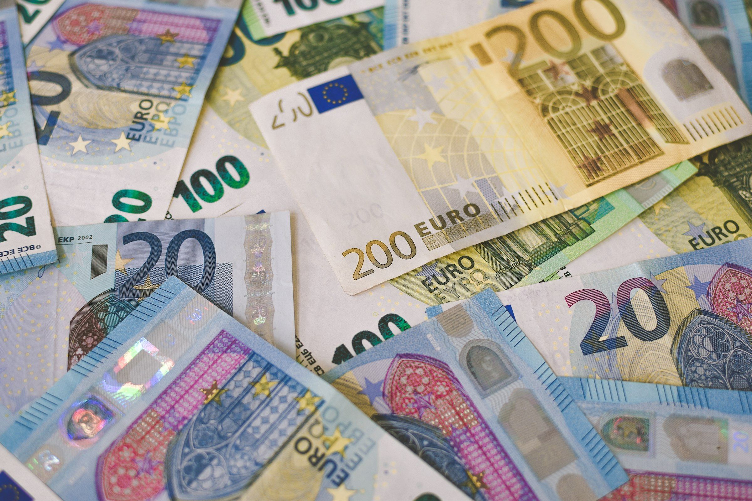 A scattered pile of 20, 100 and 200 euro banknotes