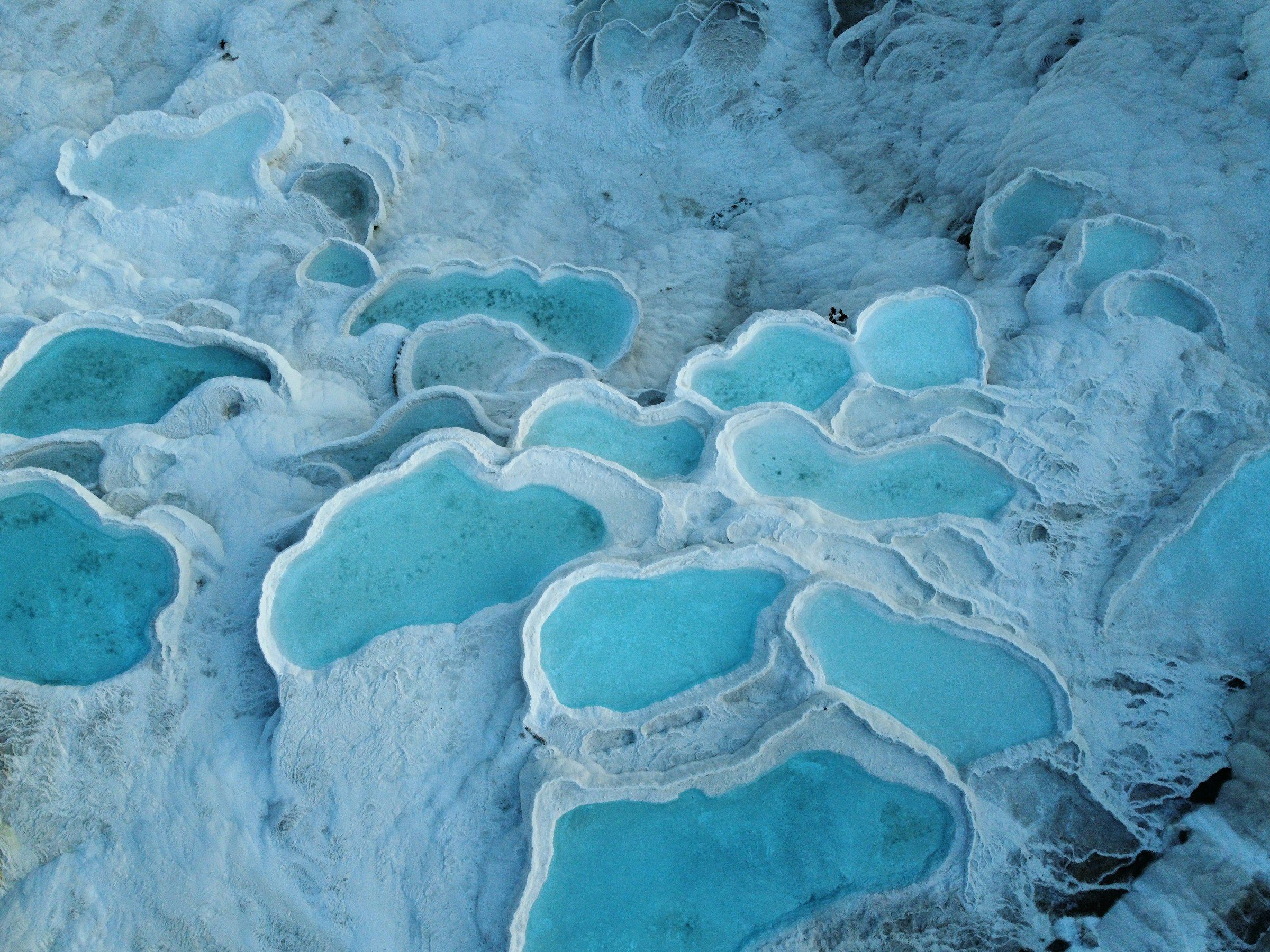 Blaues Wasser in weißen Sinterbecken in Pamukkale